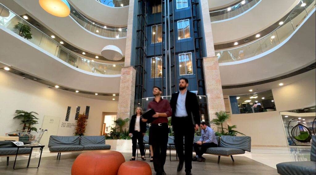 SMP lawyers walking through the atrium of the firm's office building